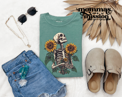 skeleton and sunflower blooms